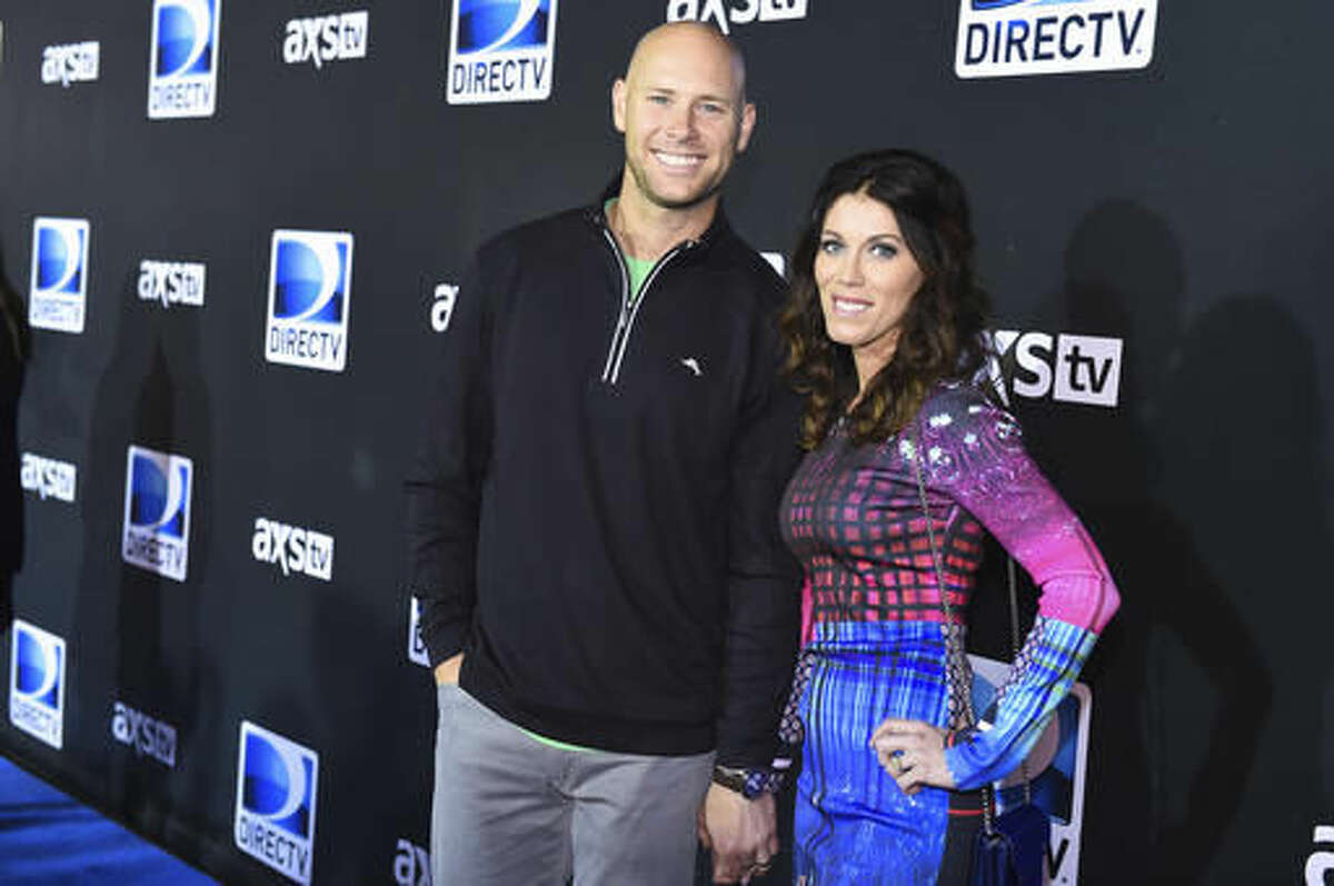 FILE - In this Saturday, Jan. 31, 2015, file photo, Josh Brown, left, and Molly Brown arrive at the 2015 DIRECTV Super Saturday Night at the Pendergast Family Farm, in Glendale, Ariz. Coach Ben McAdoo said Friday, Oct. 21, 2016, that the New York Giants have not yet decided whether Josh Brown will remain on the team after admitting to abuse of his former wife. McAdoo faced repeated questioning about the kicker following the Giants' first practice in London for a game Sunday against the Los Angeles Rams. (Photo by Scott Roth/Invision/AP, File)