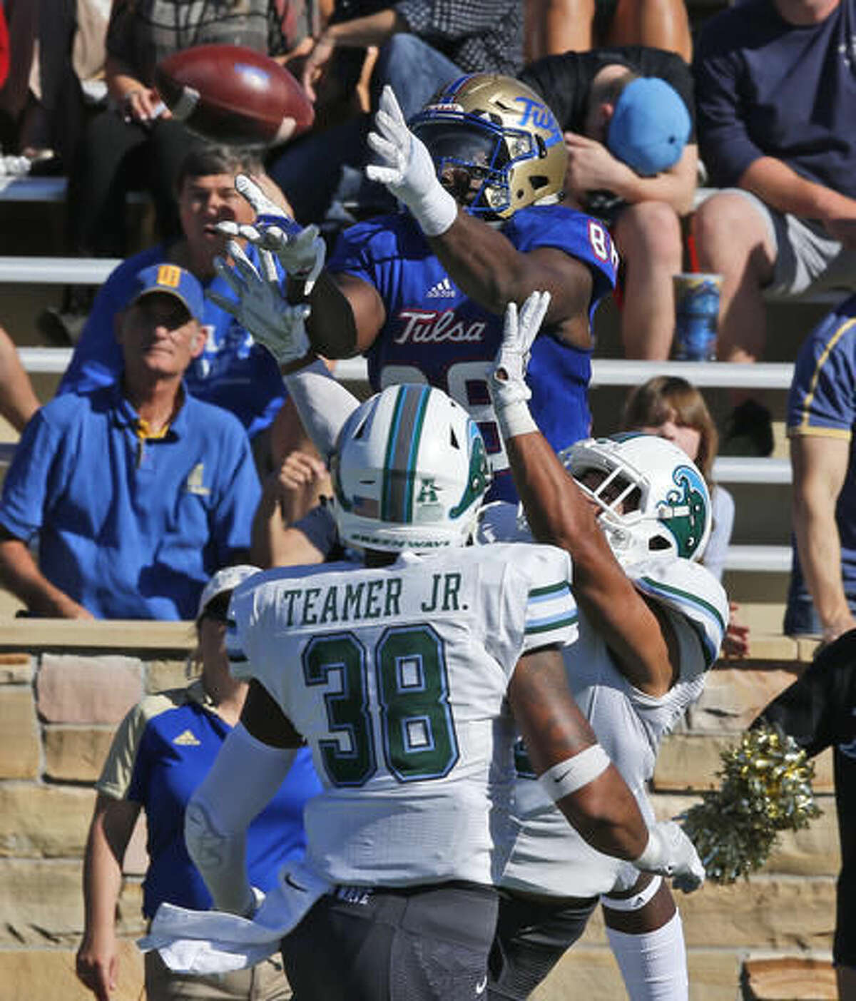 Tulsa wide receiver Josh Atkinson (88) jumps to catch a pass in front of Tulane safety Roderic Teamer (38) and Richard Allen, center, in the first quarter of an NCAA college football game in Tulsa, Okla., Saturday, Oct. 22, 2016. Atkinson took the pass in for a touchdown. (AP Photo/Sue Ogrocki)