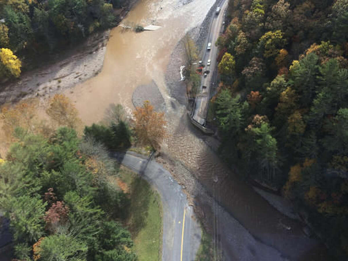 This photo provided by Sunoco Logistics shows an aerial view from a helicopter where a pipeline runs under Wallis Run, lower right, just to the left of where a bridge used to be on Loyalsock Creek, Saturday afternoon, Oct. 22, 2016, in Gamble Township, Pa. Extensive flooding early Friday knocked out the bridge and caused an 8-inch Sunoco Logistics pipeline to rupture, spilling nearly 55,000 gallons of gasoline into a tributary of the creek. (Sunoco Logistics via AP)