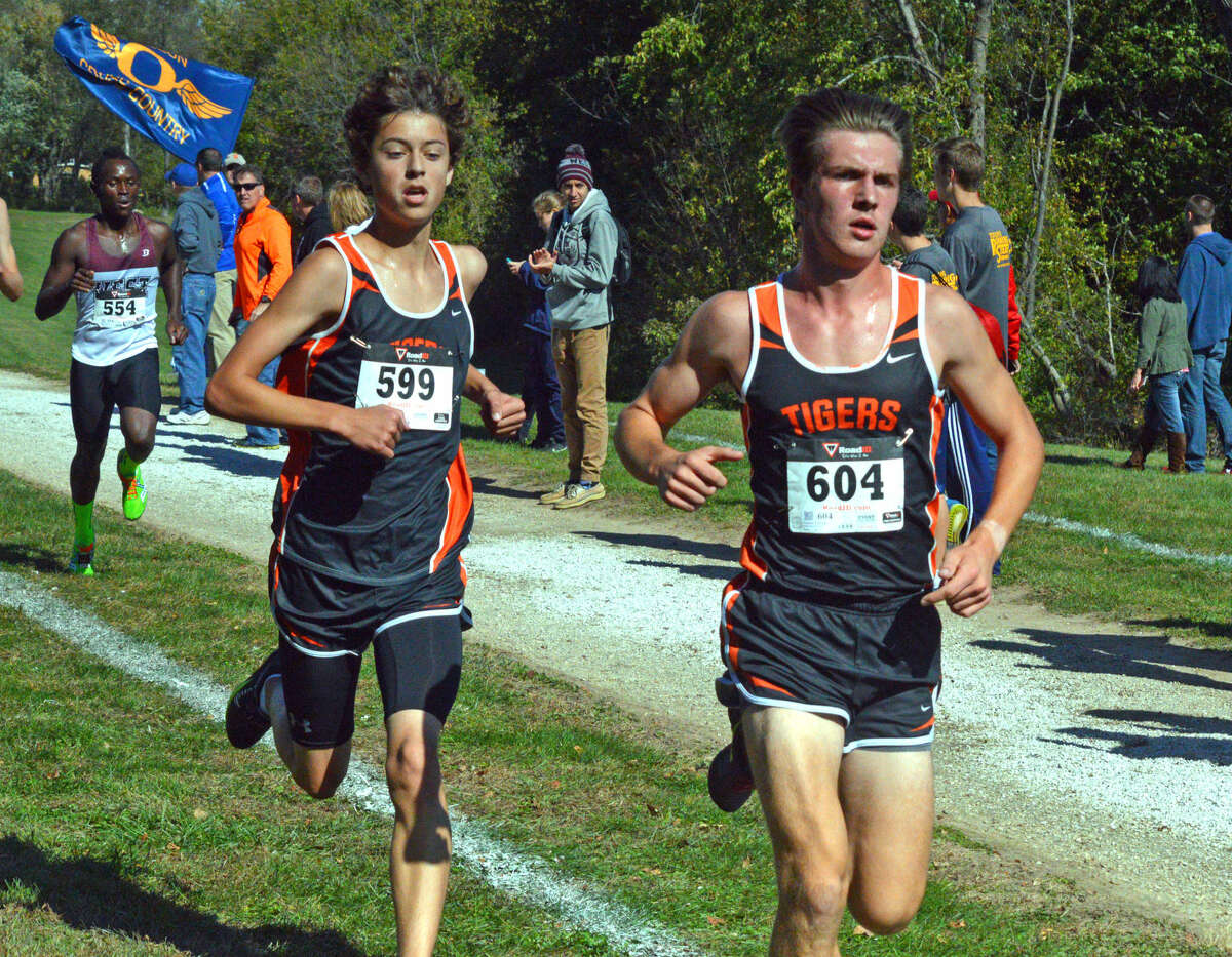 Edwardsville’s Max Hartmann (No. 599) and Roland Prenzler compete in the boys’ race during Saturday’s Class 3A Quincy Regional at Bob Mays Park.