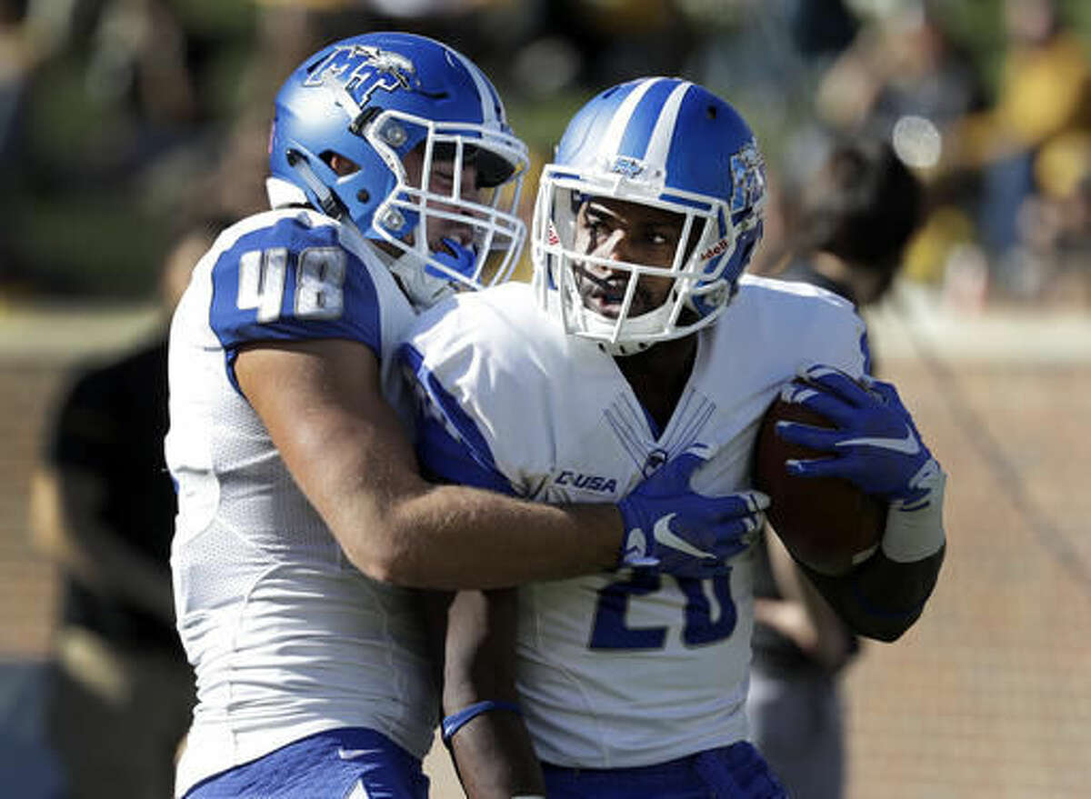 Middle Tennessee wide receiver Dennis Andrews, right, is congratulated by teammate Max Linder after scoring during the first half of an NCAA college football game against Missouri, Saturday, Oct. 22, 2016, in Columbia, Mo. (AP Photo/Jeff Roberson)