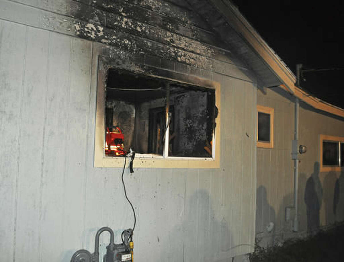 This photo provided by the Spokane, Wash., Fire Department shows the exterior of a home where a toddler and his dog died in a fire, seen Saturday, Oct. 22, 2016. The toddler was found with his dog and teddy bear next to him, and authorities believe the dog tried to protect the boy in the fire that broke out around 11:30 p.m. Friday, a spokesman for Spokane's fire department said Saturday. (Spokane Fire Department via AP)