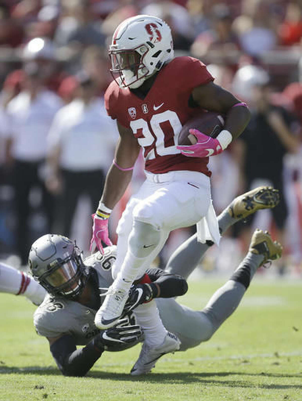 Stanford's Bryce Love, right, breaks the tackle of Colorado's Jimmie Gilbert (98) during the first half of an NCAA college football game, Saturday, Oct. 22, 2016, in Stanford, Calif. (AP Photo/Ben Margot)