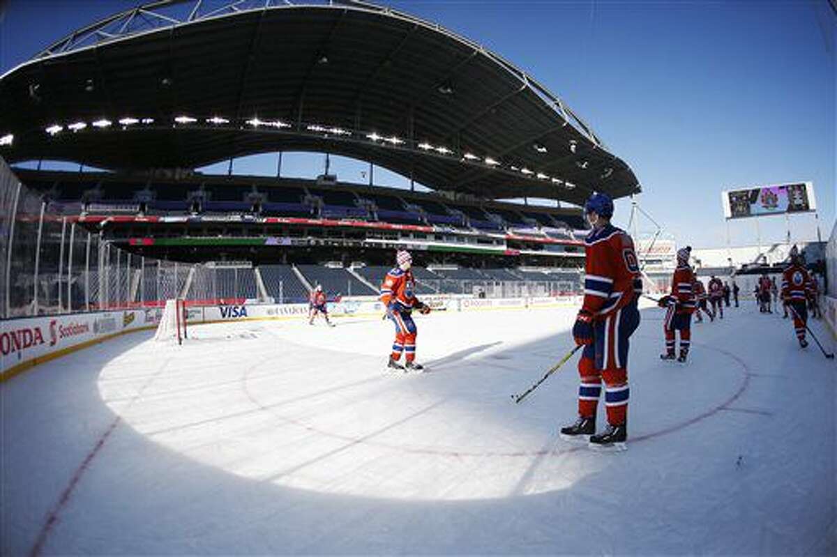 Edmonton Oilers' Connor McDavid (97) watches over his team during practice at Investors Group Field for the NHL Heritage Classic outdoor hockey game in Winnipeg, Manitoba, Saturday, Oct. 22, 2016. The Oilers taken on the Winnipeg Jets Sunday. (John Woods/The Canadian Press via AP)