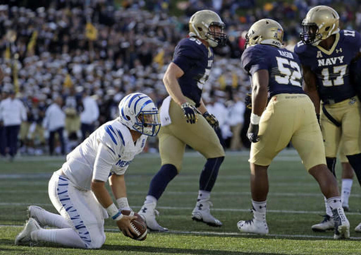 Memphis quarterback Riley Ferguson, left, gets up after not being able to convert for a first down near the goal line in front of, from back left, Navy linebacker Ted Colburn, defensive end Amos Mason and cornerback Tyris Wooten in the first half of an NCAA college football game in Annapolis, Md., Saturday, Oct. 22, 2016. (AP Photo/Patrick Semansky)