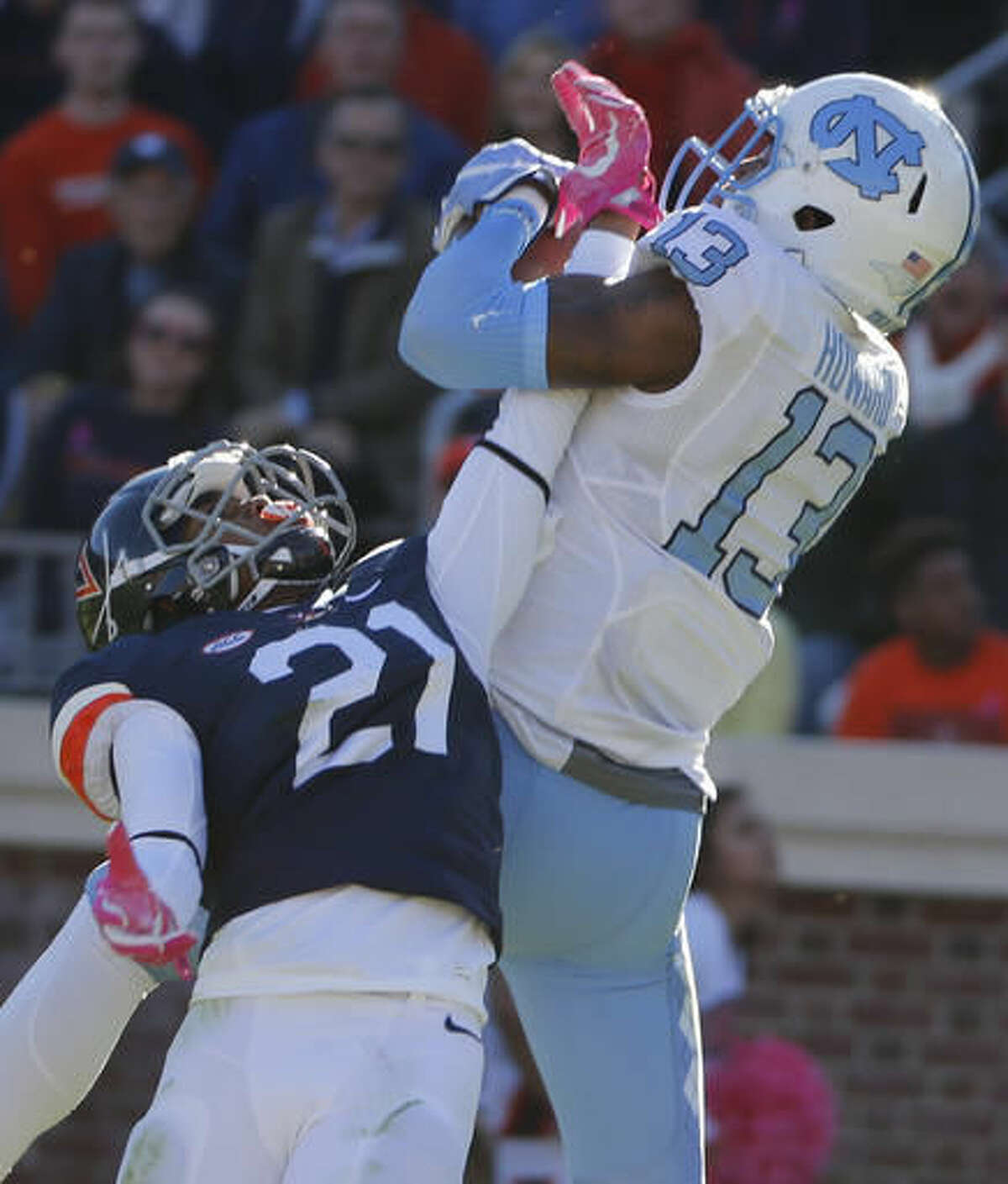 North Carolina wide receiver Bug Howard (84) hauls in a touchdown pass in front of Virginia safety Juan Thornhill (21) during the first half of an NCAA college football game between North Carolina and Virginia at Scott stadium in Charlottesville, Va., Saturday, Oct. 22, 2016. (AP Photo/Steve Helber)