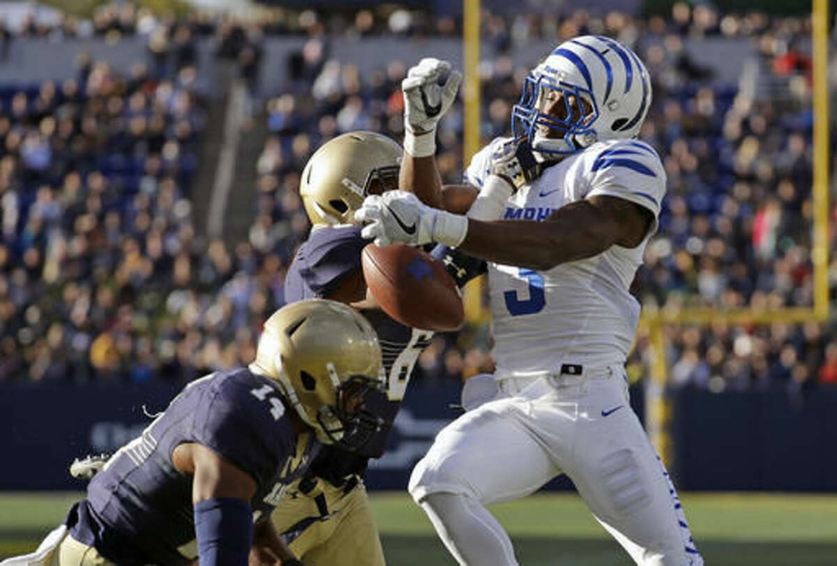 A pass-attempt in the end zone to Memphis wide receiver Anthony Miller, right, is broken up by Navy safety Sean Williams, center, and cornerback Elijah Merchant in the first half of an NCAA college football game in Annapolis, Md., Saturday, Oct. 22, 2016. (AP Photo/Patrick Semansky)