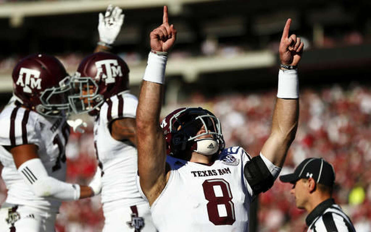 Texas A&M quarterback Trevor Knight (8) celebrates after wide receiver Josh Reynolds scored a touchdown during the first half of an NCAA college football game against Alabama, Saturday, Oct. 22, 2016, in Tuscaloosa, Ala. (AP Photo/Brynn Anderson)