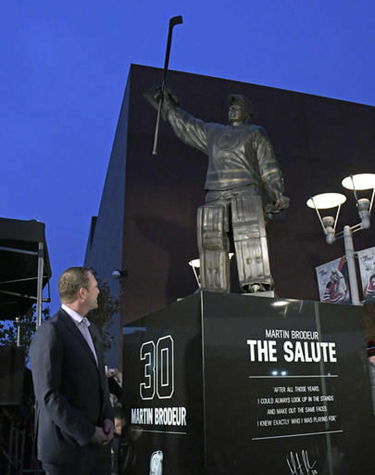 Former New Jersey Devils goaltender Martin Brodeur looks at his statue which was unveiled outside the Prudential Center before the Devils' NHL hockey game against the Minnesota Wild, Saturday, Oct. 22, 2016, in Newark, N.J. (AP Photo/Bill Kostroun)