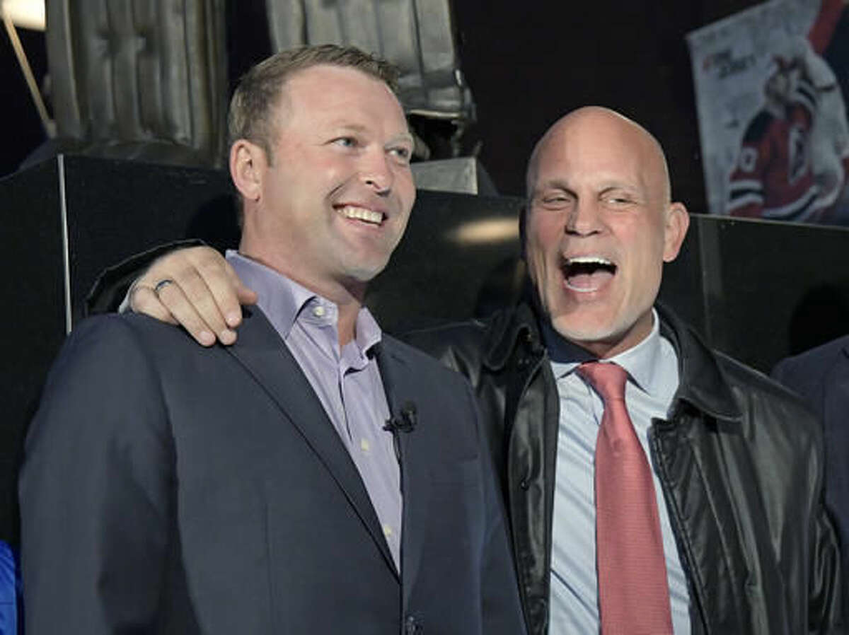 Former New Jersey Devils goaltender Martin Brodeur, left, and former Devils defenseman Ken Daneyko talk after the unveiling of a statue of Brodeur outside the Prudential Center before the Devils' NHL hockey game against the Minnesota Wild, Saturday, Oct. 22, 2016, in Newark, N.J. (AP Photo/Bill Kostroun)