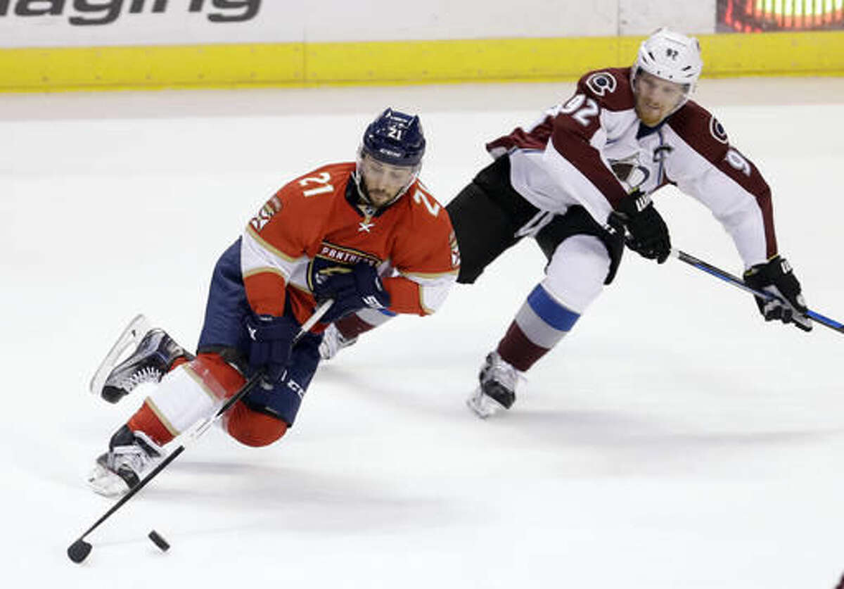 Florida Panthers center Vincent Trocheck (21) skates with the puck as Colorado Avalanche left wing Gabriel Landeskog (92) defends in the second period of an NHL hockey game, Saturday, Oct. 22, 2016, in Sunrise, Fla. (AP Photo/Alan Diaz)