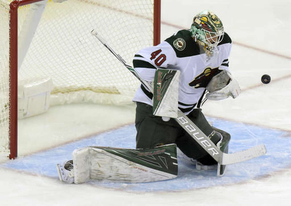 Minnesota Wild goaltender Devan Dubnyk makes a save during the second period of an NHL hockey game against the New Jersey Devils, Saturday, Oct. 22, 2016, in Newark, N.J. (AP Photo/Bill Kostroun)
