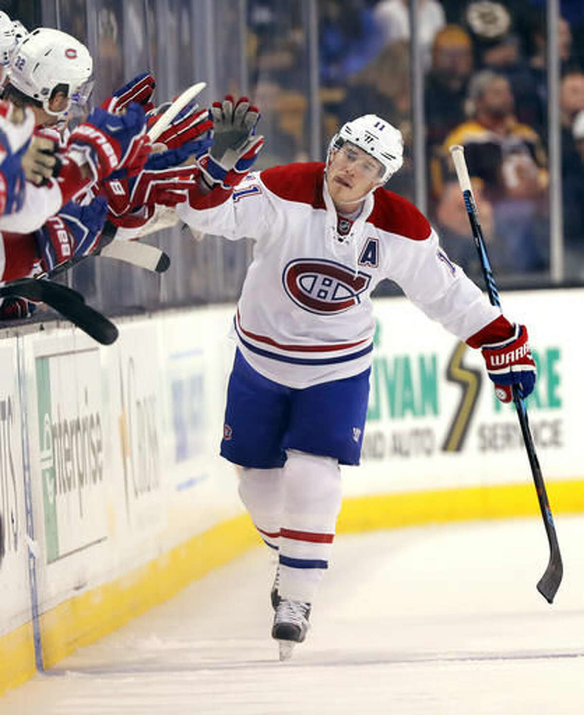 Montreal Canadiens' Brendan Gallagher is congratulated at the bench after scoring against the Boston Bruins during the second period of an NHL hockey game in Boston on Saturday, Oct. 22, 2016. (AP Photo/Winslow Townson)