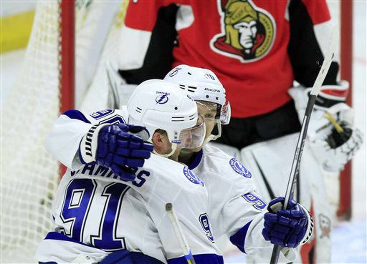 Tampa Bay Lighting's Steven Stamkos (91) celebrates his goal against the Ottawa Senators with teammate Vladislav Namestnikov (90) during the second period of an NHL hockey game Saturday, Oct. 22, 2016, in Ottawa, Ontario. (Fred Chartrand/The Canadian Press via AP)