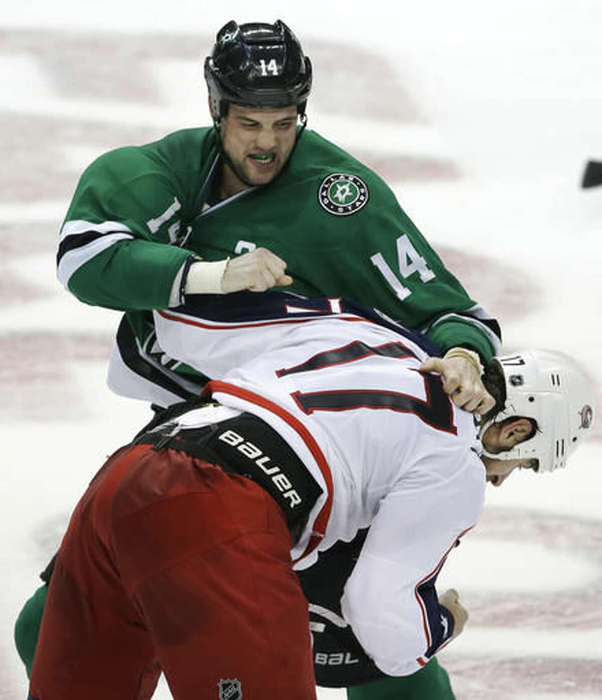 Dallas Stars left wing Jamie Benn (14) and Columbus Blue Jackets center Brandon Dubinsky (17) fight during the second period of an NHL hockey game Saturday, Oct. 22, 2016, in Dallas. (AP Photo/LM Otero)