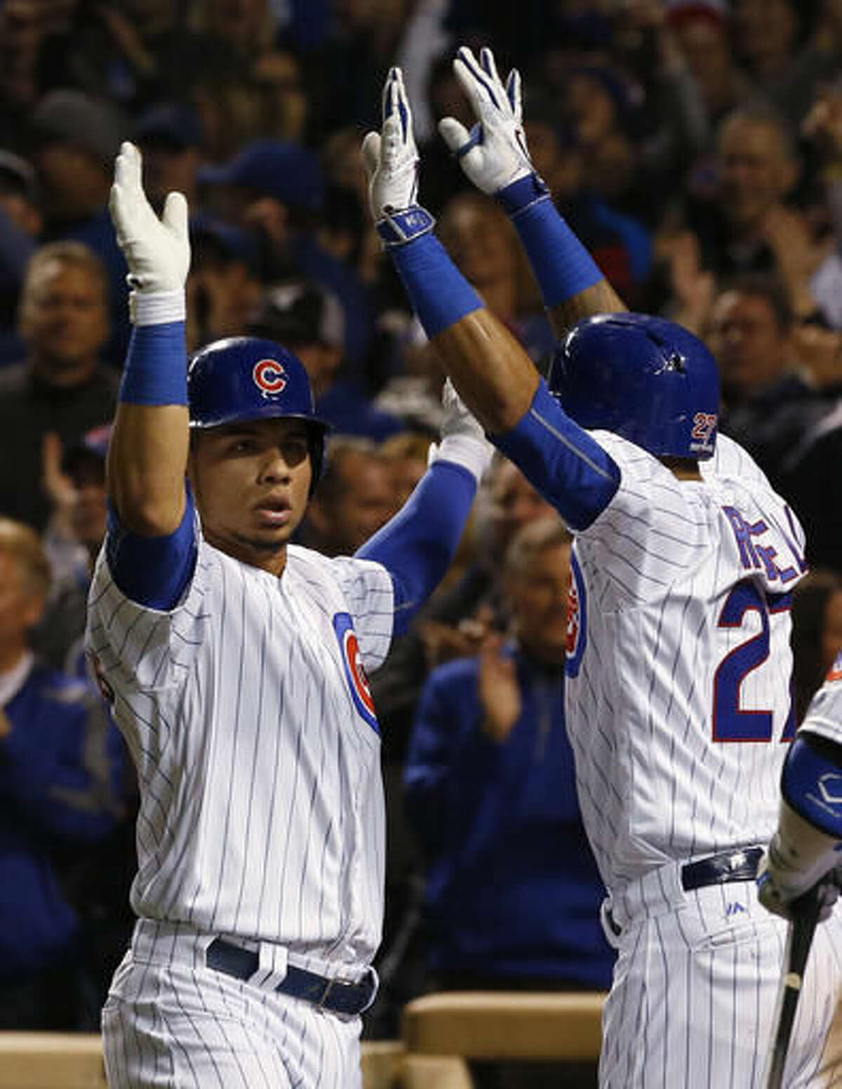 Chicago Cubs' Willson Contreras, left, celebrates with Addison Russell after hitting a home run during the fourth inning of Game 6 of the National League baseball championship series against the Los Angeles Dodgers, Saturday, Oct. 22, 2016, in Chicago. (AP Photo/Nam Y. Huh)