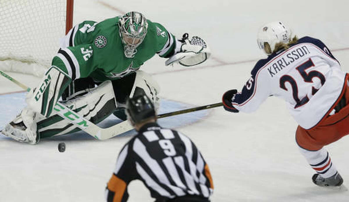 Dallas Stars goalie Kari Lehtonen (32) defends the goal against Columbus Blue Jackets center William Karlsson (25) as referee Dan O'Rourke (9) looks on during the second period of an NHL hockey game Saturday, Oct. 22, 2016, in Dallas. (AP Photo/LM Otero)