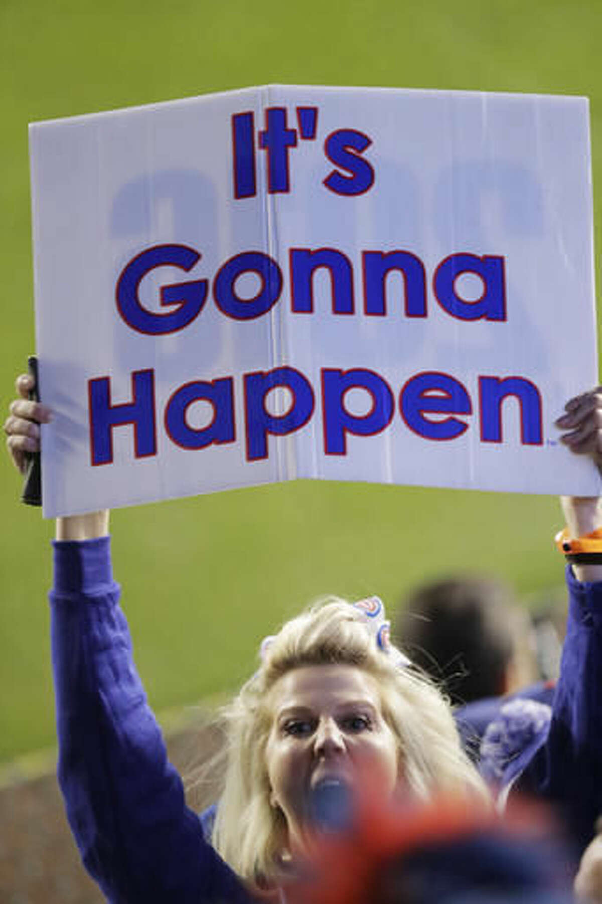 A Chicago Cubs fan holds up a sign during the eighth inning of Game 6 of the National League baseball championship series between the Chicago Cubs and the Los Angeles Dodgers Saturday, Oct. 22, 2016, in Chicago. (AP Photo/Charles Rex Arbogast)