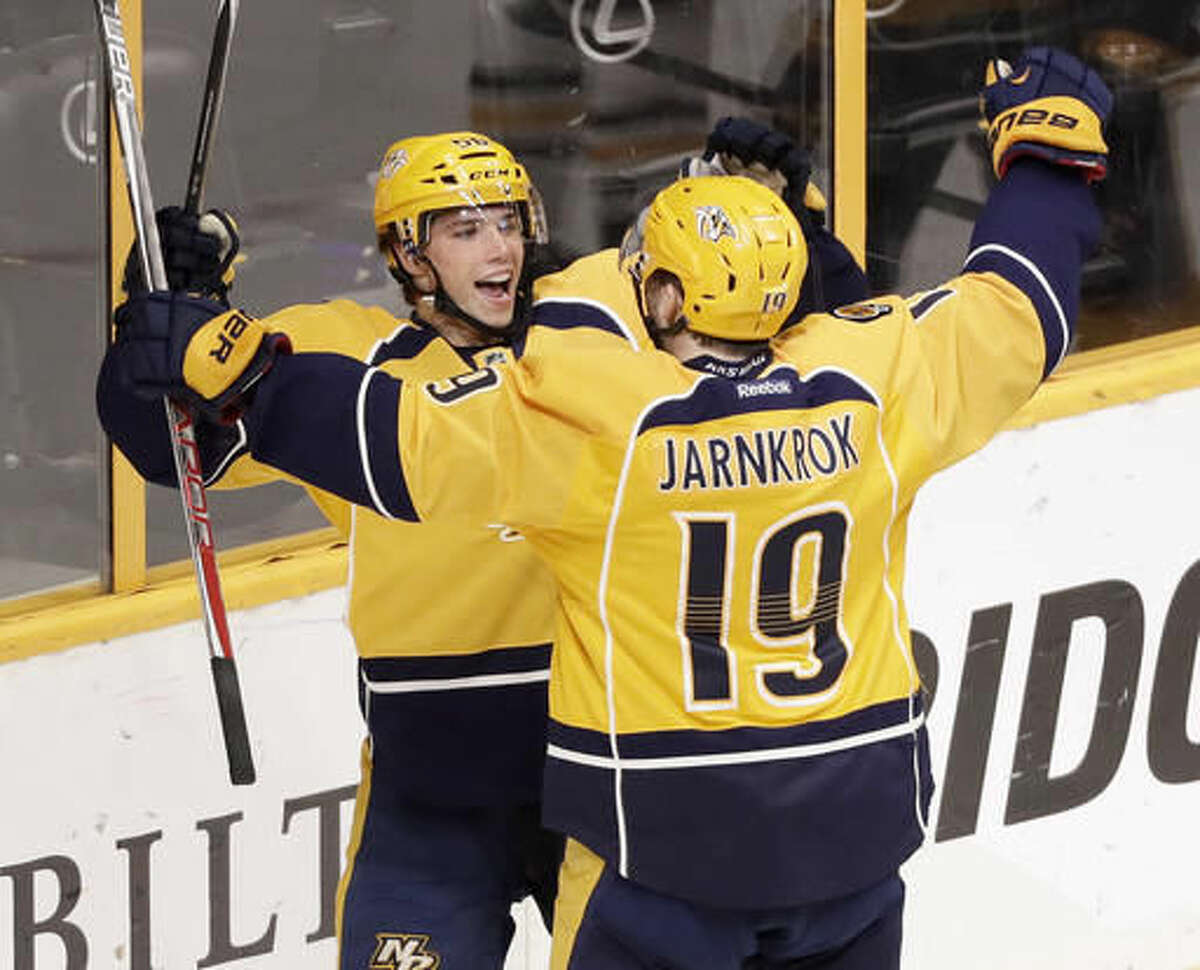 Nashville Predators left wing Kevin Fiala, top, of Switzerland, celebrates with Calle Jarnkrok (19), of Sweden, after Fiala scored against the Pittsburgh Penguins during the second period of an NHL hockey preseason game Saturday, Oct. 22, 2016, in Nashville, Tenn. (AP Photo/Mark Humphrey)