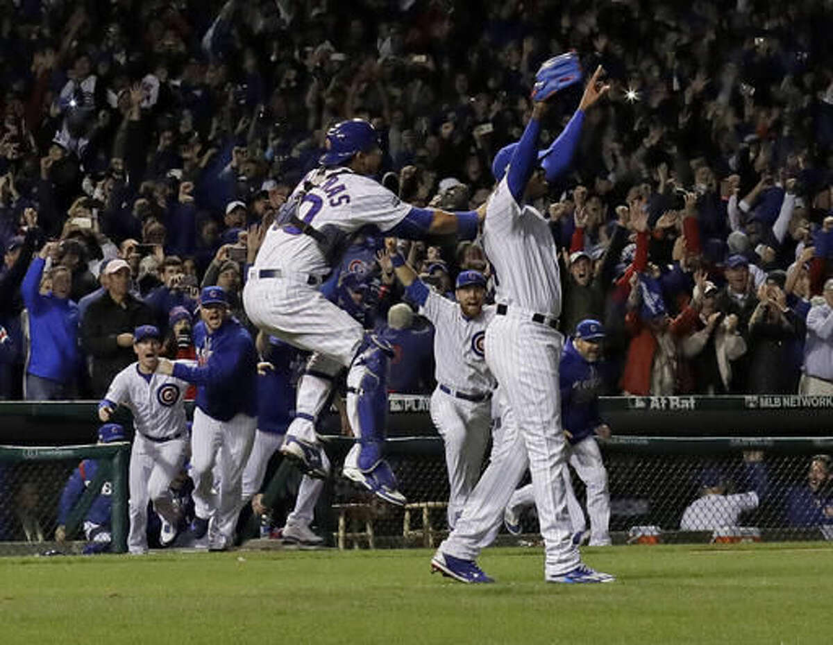 Chicago Cubs relief pitcher Aroldis Chapman (54) and catcher Willson Contreras (40) celebrate after Game 6 of the National League baseball championship series against the Los Angeles Dodgers, Saturday, Oct. 22, 2016, in Chicago. The Cubs won 5-0 to win the series and advance to the World Series against the Cleveland Indians. (AP Photo/David J. Phillip)