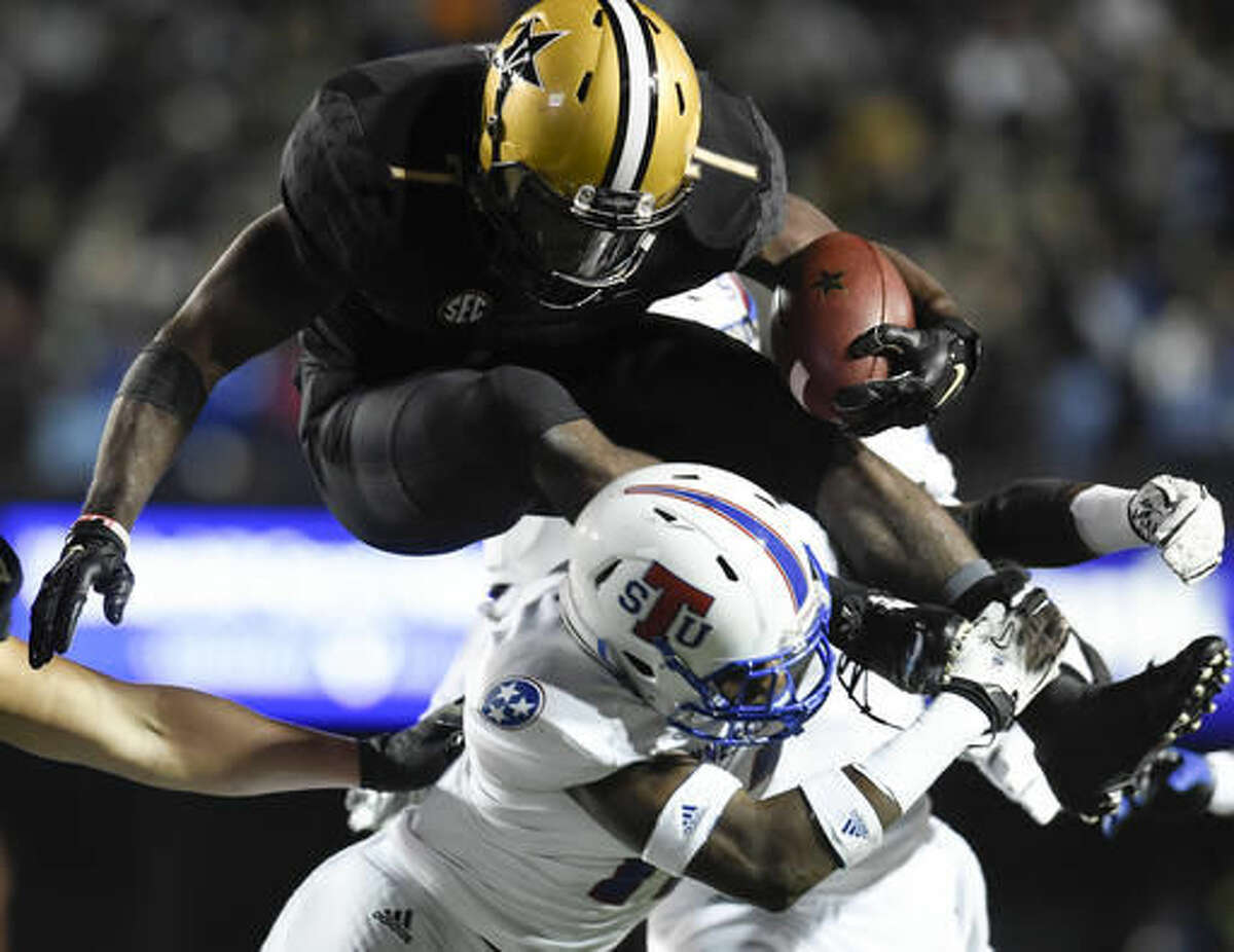 Vanderbilt running back Ralph Webb (7) jumps over a Tennessee defender during the first half of an NCAA college football game Saturday, Oct. 22, 2016, in Nashville, Tenn. (George Walker IV/The Tennessean via AP)