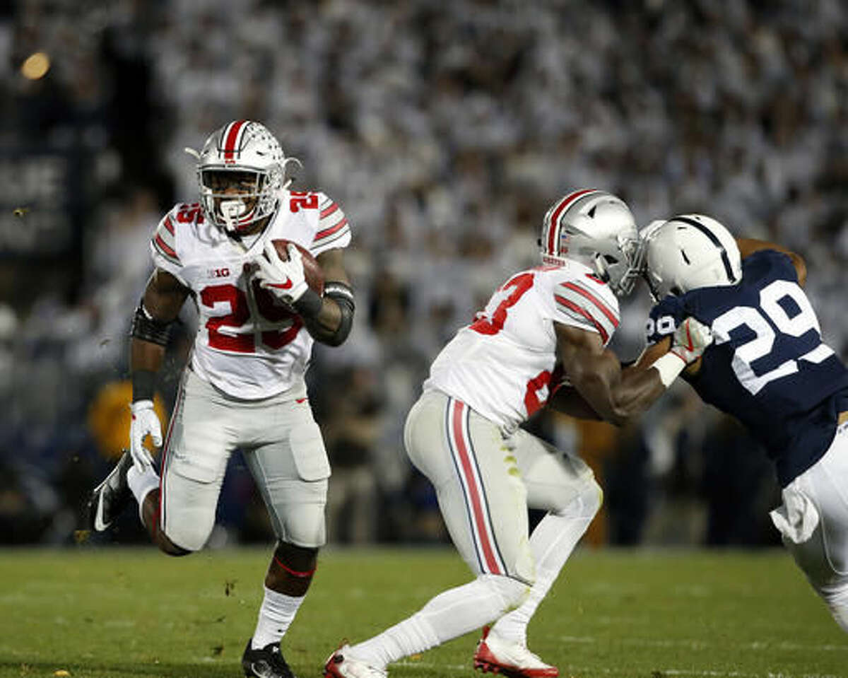 Ohio State's Mike Weber (25) takes off running against Penn State during the first half of an NCAA college football game in State College, Pa., Saturday, Oct. 22, 2016. (AP Photo/Chris Knight)
