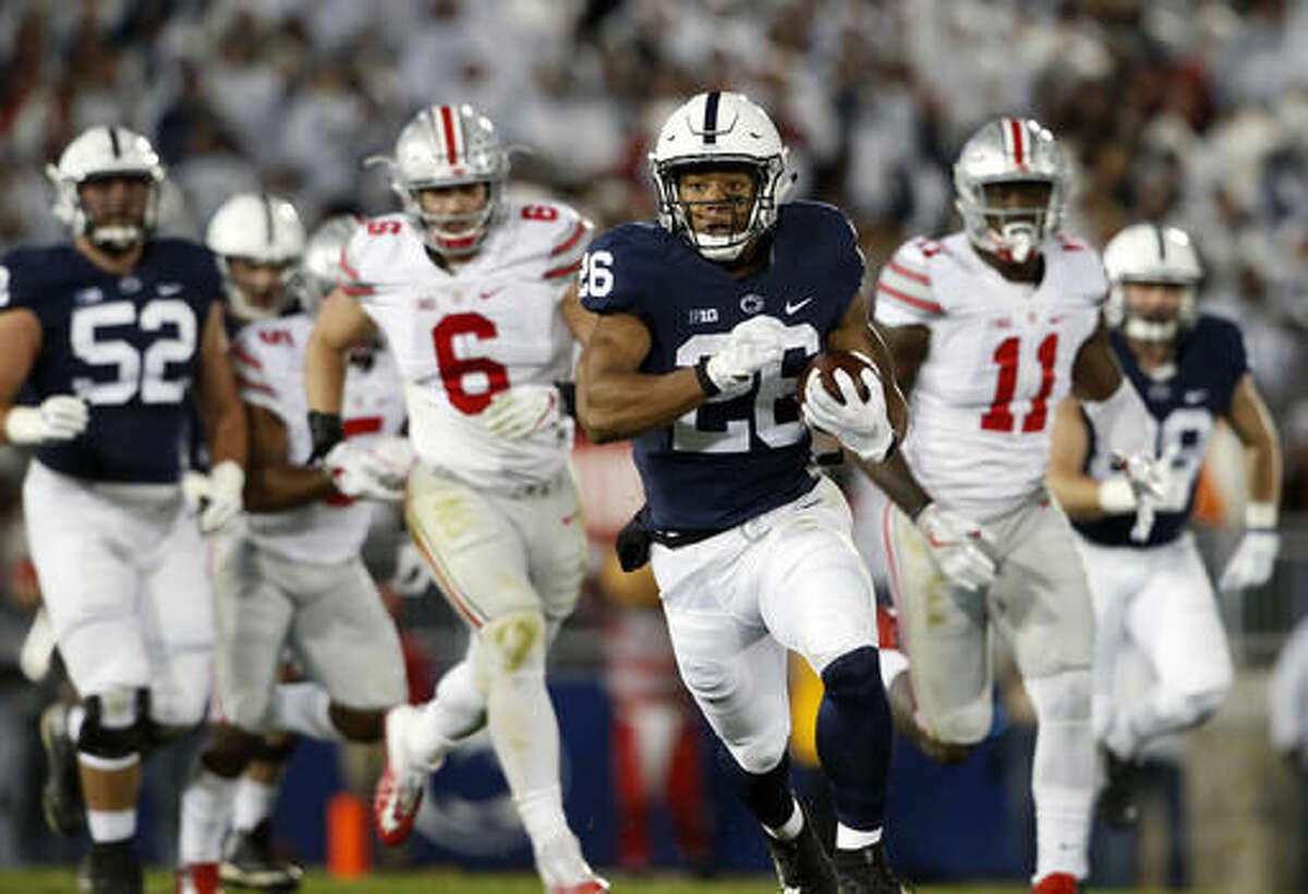 Penn State's Saquon Barkley (26) runs the ball against Ohio State during the first half of an NCAA college football game in State College, Pa., Saturday, Oct. 22, 2016. (AP Photo/Chris Knight)