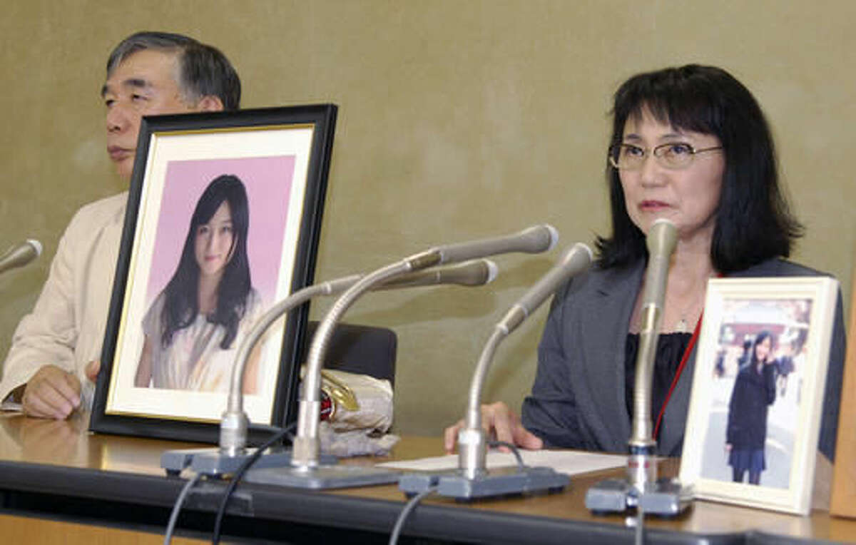 In this Oct. 7, 2016 photo, Yukimi Takahashi, right, mother of Matsuri, with lawyer Hiroshi Kawahito, speaks to journalists at a news conference in Tokyo after her daughter's suicide was recognized as “karoshi,” or death from overwork. Matsuri Takahashi’s dream career at Japan’s top ad agency, Dentsu, ended with her suicide after her overtime exceeded 100 hours a month. (Kyodo News via AP)