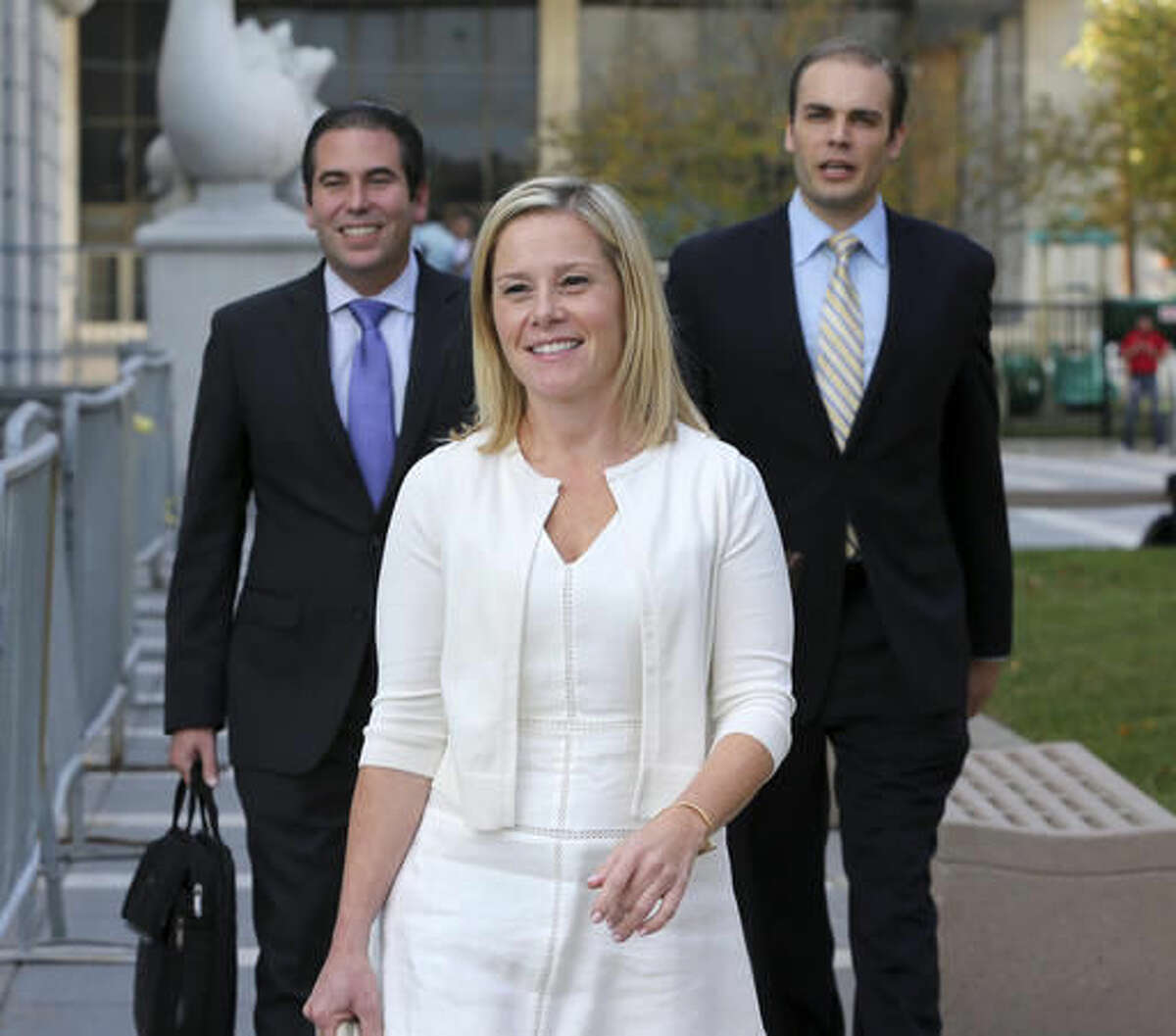 FILE - In this Wednesday, Oct. 19, 2016 file photo, Gov. Chris Christie's former Deputy Chief of Staff Bridget Anne Kelly, center, leaves Martin Luther King Jr. Courthouse after a hearing, in Newark, N.J. Kelly, who prosecutors say sent the "time for some traffic problems" email that started the George Washington Bridge lane-closing scandal is set to testify in her own defense. Kelly is expected to take the stand later Friday, Oct. 21, 2016, in federal court in Newark. (AP Photo/Mel Evans, File)