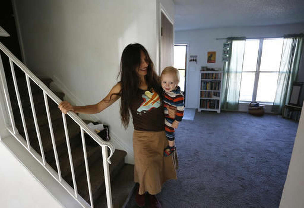 In this Thursday, Oct. 20, 2016 photo, vegan mother Fulvia Serra carries her 1-year-old baby, Sebastiano, at home in Fort Collins, Colo. Serra, originally from Italy, and her husband, Scott, are raising their son vegan. Despite criticism and innuendo from some circles, pediatricians and nutritionists agree it's perfectly healthy to feed babies a vegan diet. However, parents need to be well-informed about the nutritional elements different foods offer, and work closely with their doctor or health care provider. (AP Photo/Brennan Linsley)