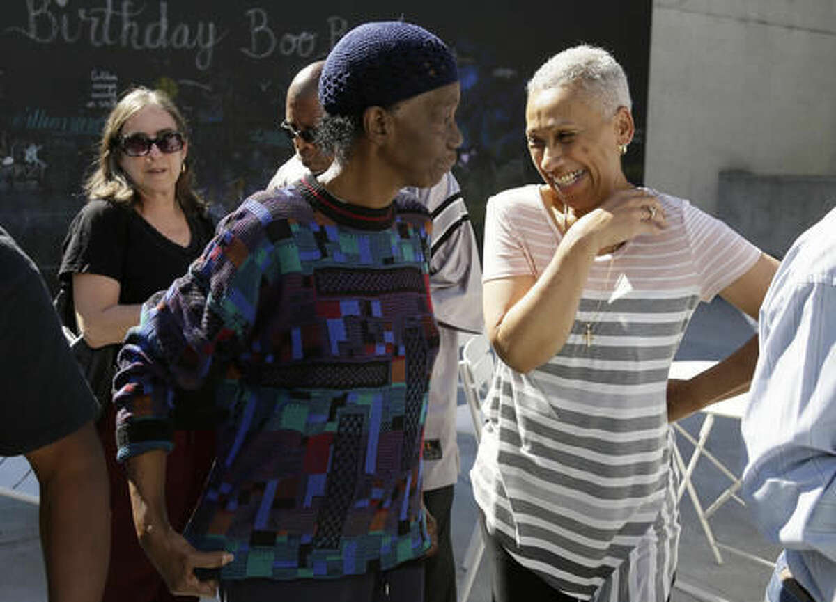 In this photo taken Saturday, Oct. 8, 2016, former Black Panther Party members Lorene Johnson, center, and M. Gayle Asali-Dickson, right, visit outside a museum after an anniversary meeting in Oakland, Calif. Hundreds of former Black Panthers from around the world are expected to gather in Oakland, Calif., for a four-day conference that started Thursday, Oct. 20, 2016. The Panthers emerged from the gritty city 50 years ago, declaring a new party dedicated to defending African-Americans against police brutality and protecting their rights. (AP Photo/Eric Risberg)