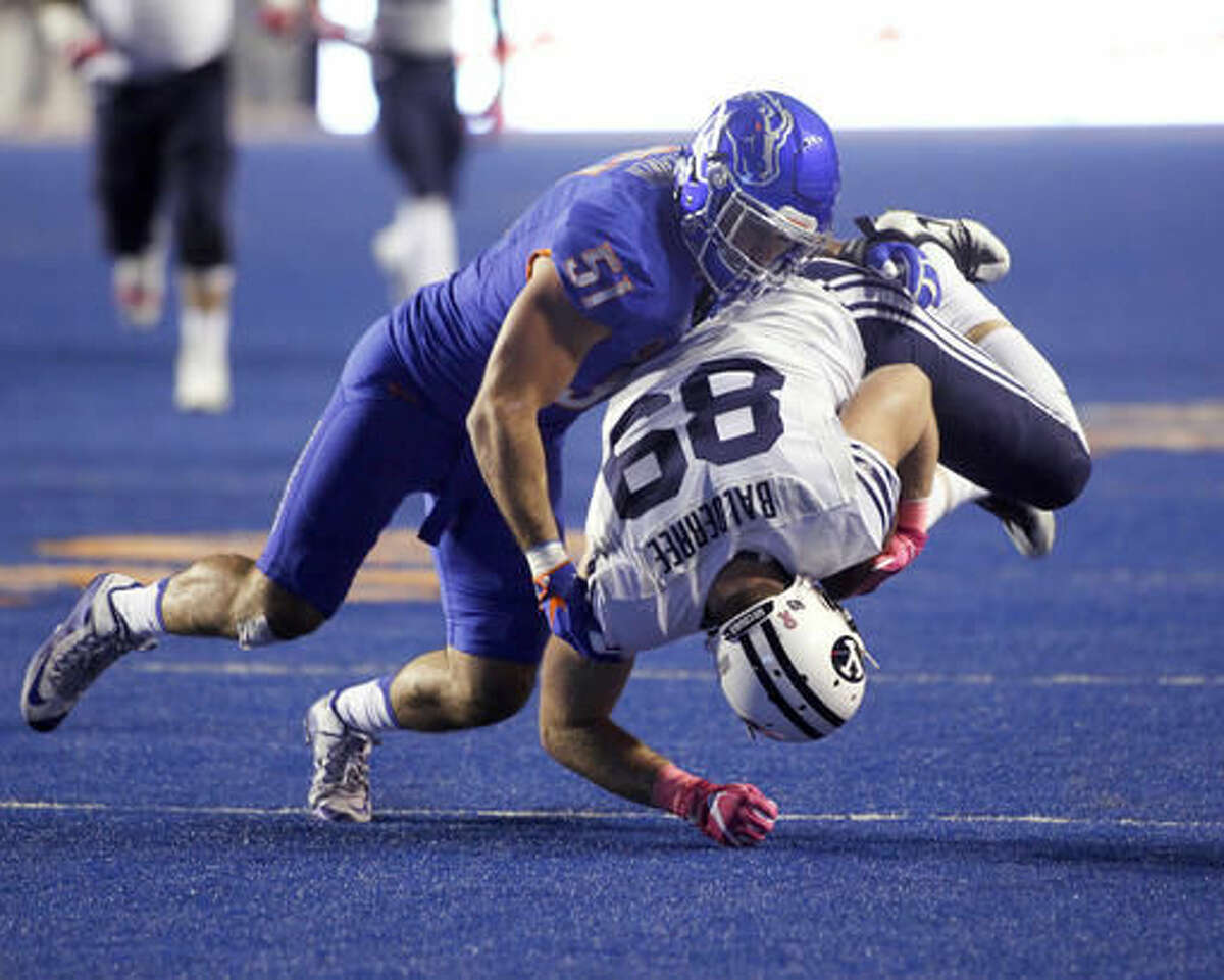 BYU tight end Tanner Balderree (89) is brought down by Boise State linebacker Ben Weaver (51) during the first half of an NCAA college football game in Boise, Idaho, Thursday, Oct. 20, 2016. (AP Photo/Otto Kitsinger)