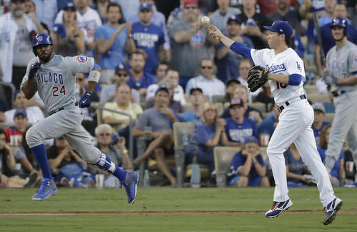 Los Angeles Dodgers' Kenta Maeda throws out Chicago Cubs' Dexter Fowler (24) during the second inning of Game 5 of the National League baseball championship series Thursday, Oct. 20, 2016, in Los Angeles. (AP Photo/Jae C. Hong)