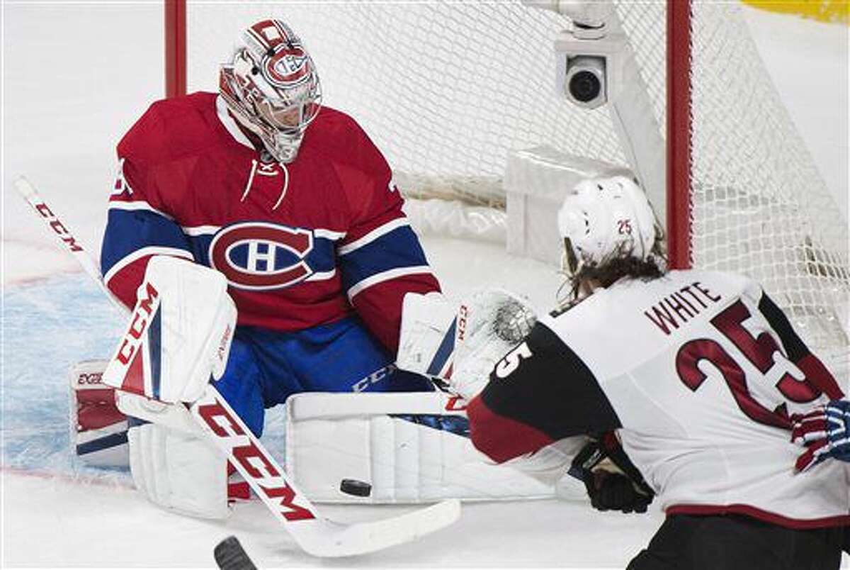 Montreal Canadiens goaltender Carey Price makes a save against Arizona Coyotes' Ryan White during the first period of an NHL hockey game, Thursday, Oct. 20, 2016 in Montreal. (Graham Hughes/The Canadian Press via AP)