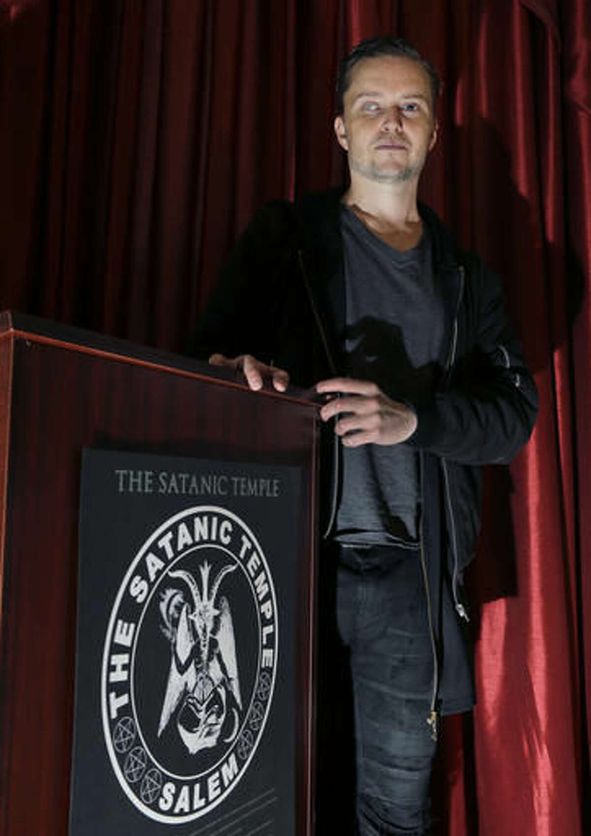 In this Oct. 24, 2016 photo, Lucien Greaves stands inside the recently opened international headquarters of the Satanic Temple in Salem, Mass. The Satanic Temple is waging religious battles along a variety of fronts nationwide, and its co-founder says it's just getting started. Greaves says the temple hopes to ensure Satanists "have a place in the world" and that "evangelical theocrats" don't monopolize the religious freedom debate. (AP Photo/Elise Amendola)