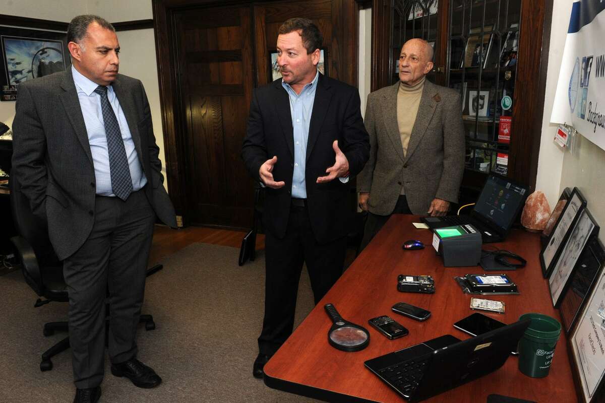 Al Dressler, Chief Executive Officer of FaceChecks, speaks in the Central Forensic Lab at the University of Bridgeport, in Bridgeport, Conn. Nov. 30, 2016. Dressler is seen here with Tarek Sobh, Dean of the university?’s School of Engineering, left, and Gad Selig, Dean for Industrial Outreach for the School of Engineering.