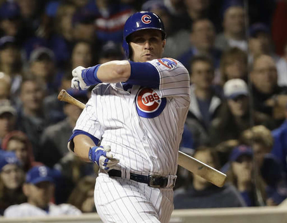 Chicago Cubs' Miguel Montero loses his bat swinging during the fifth inning of Game 3 of the Major League Baseball World Series against the Cleveland Indians Friday, Oct. 28, 2016, in Chicago. (AP Photo/David J. Phillip)