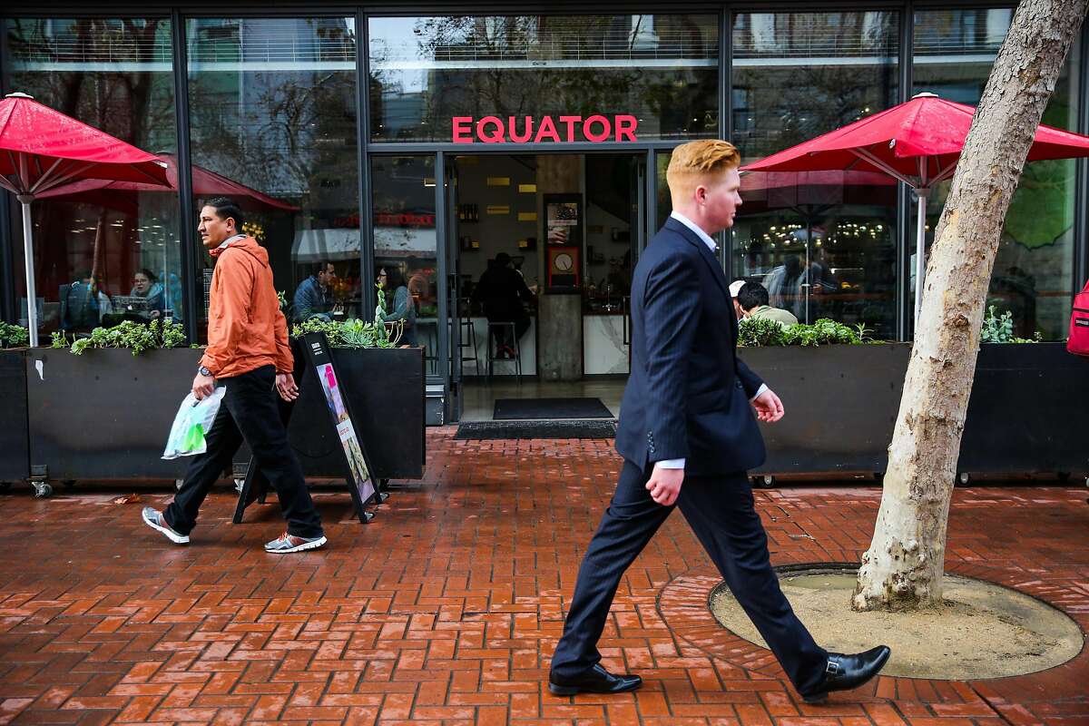People walk past Equator coffee, on Market Street, in San Francisco, California, on Wednesday, November 30, 2016.