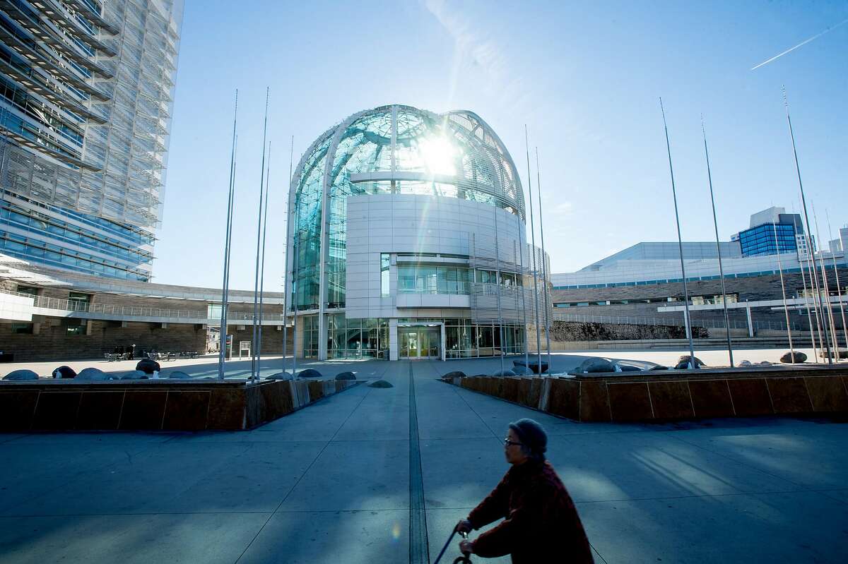 A woman passes San Jose City Hall's rotunda on Friday, Dec. 2, 2016, in San Jose, Calif.