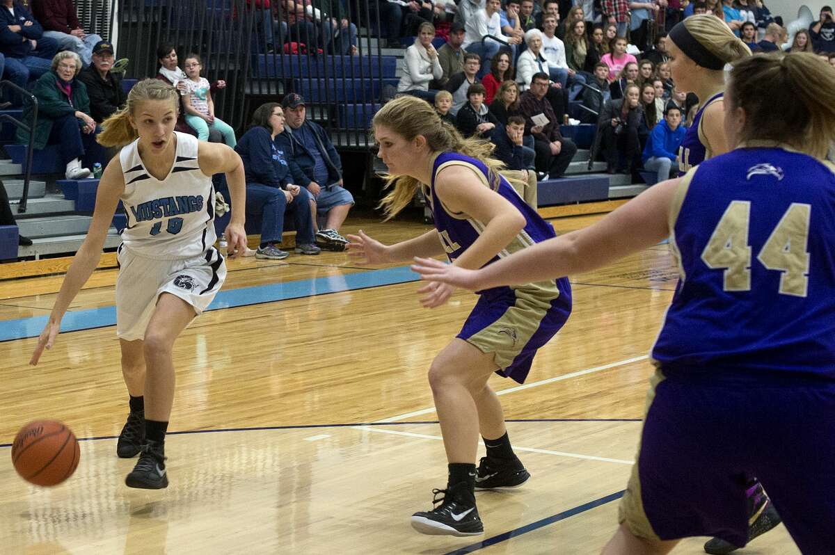 Meridian's Camryn McKellar dribbles around Farwell's Grace Saupe in the first half of Friday's game.