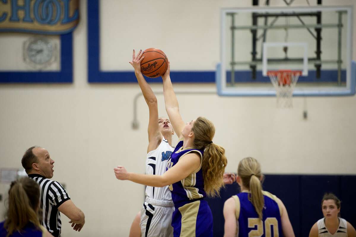 Meridian's Camryn McKellar and Farwell's Grace Saupe tip off in the first half of Friday's game.