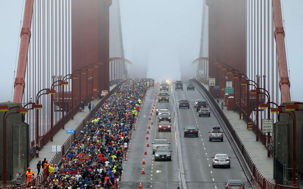 Runners and motorists make their way across the Golden Gate Bridge during the San Francisco Marathon in San Francisco, Calif., on Sunday, July 31, 2016.