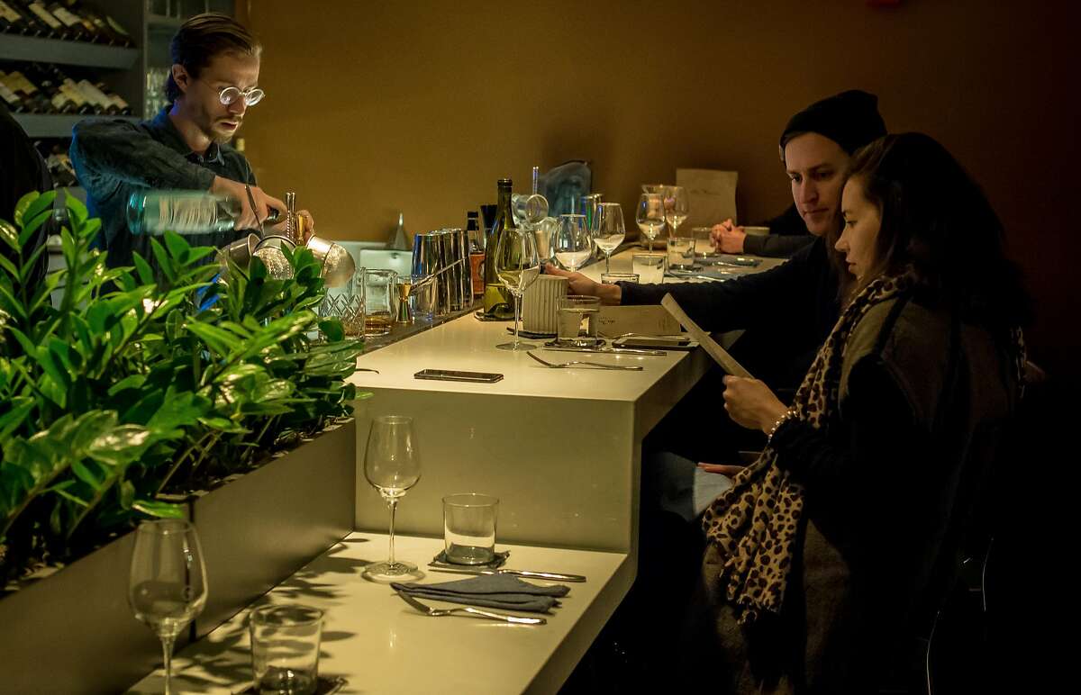 People have dinner at the bar at the Morris in San Francisco, Calif. on December 2nd, 2016.