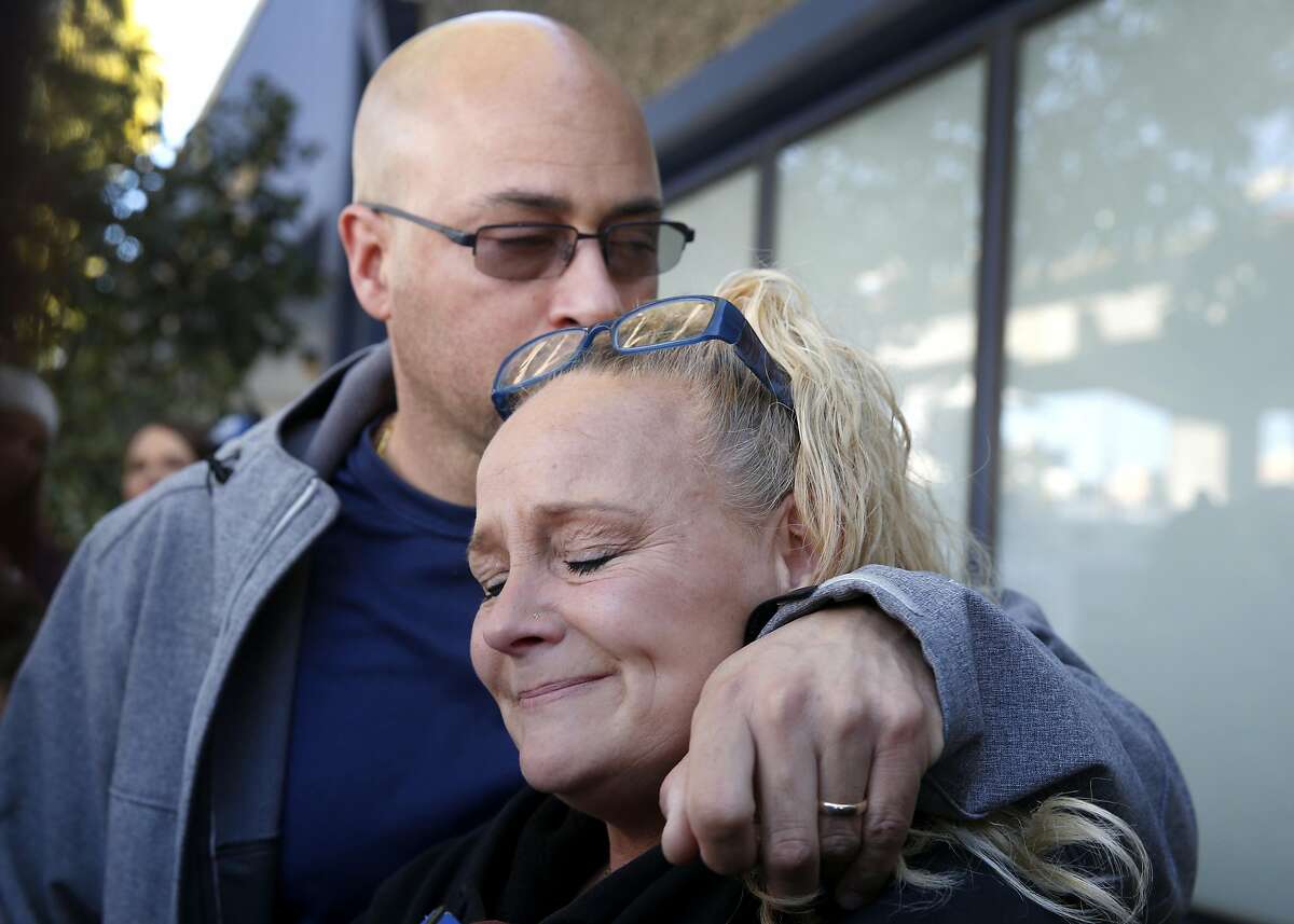 Kim Gregory and her husband David Gregory, Sr. embrace while they wait for updates at an Alameda County Sheriff's office on the fate of their daughter Michela Gregory in Oakland, Calif. on Saturday, Dec. 3, 2016 after at least nine people died and several others are unaccounted for in an overnight fire.