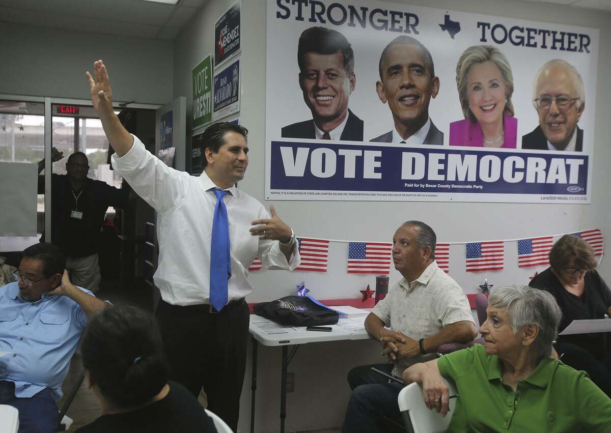 FILE PHOTO - Bexar County Democratic Party Chairman Manuel Medina (arm raised) speaks Monday August 29, 2016 to people gathered at the Democratic Party headquarters that are taking part in a phone bank effort to reach out to potential voters.