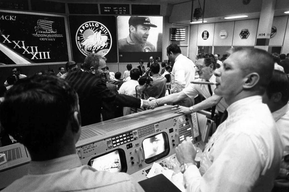 Gene Kranz, right, celebrates the Apollo 13 splashdown with a cigar at Johnson Space Center's Mission Control, April 17, 1970. (For more photos of Mission Control's glory days, scroll through the slideshow.)