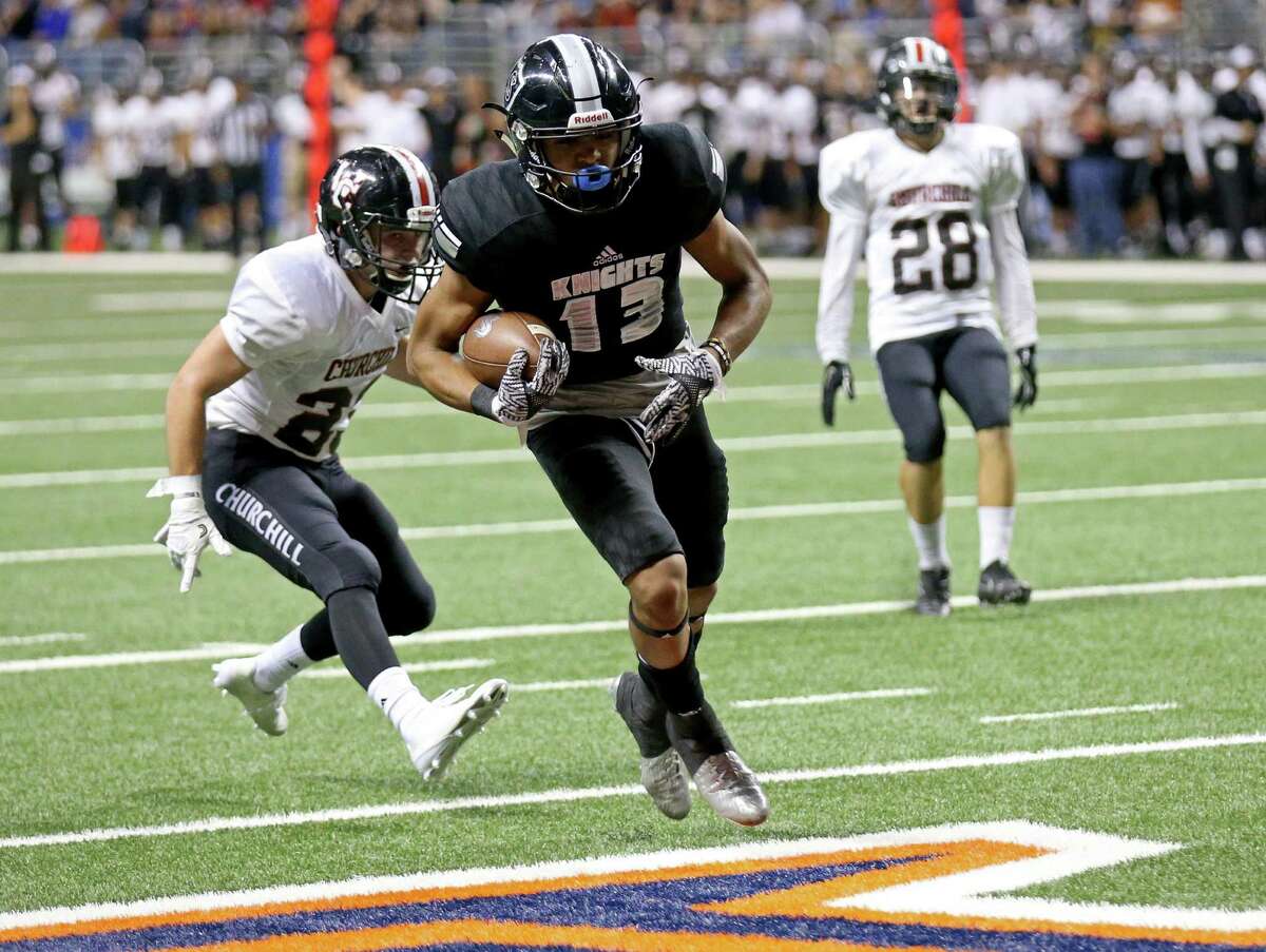 Steele's Onyx Smith scores a touchdown on a pass play ahead of Churchill's Thomas Sharrick during first half action of their Class 6A Division II state quarterfinal playoff game held Saturday Dec. 3, 2016 at the Alamodome.