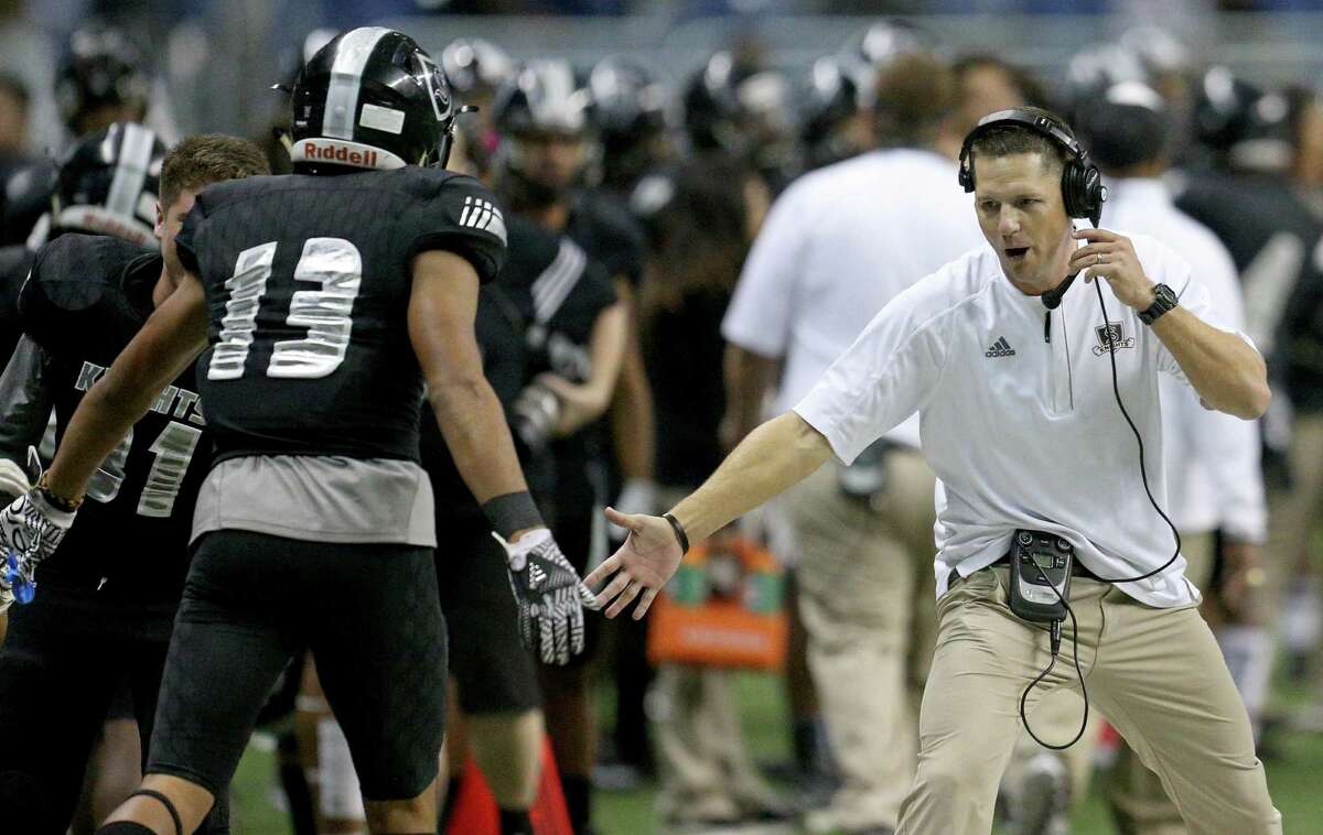 Steele’s Onyx Smith celebrates with head coach Scott Lehnhoff after scoring a touchdown against Churchill during first half action of their Class 6A Division II state quarterfinal playoff game on Dec. 3, 2016 at the Alamodome.