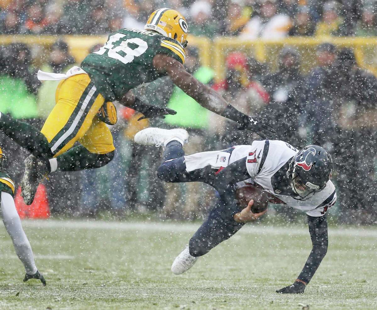 Houston Texans quarterback Brock Osweiler (17) is brought down by Green Bay Packers inside linebacker Joe Thomas (48) as he scrambles out of the pocket during the first quarter of an NFL football game at Lambeau Field on Sunday, Dec. 4, 2016, in Green Bay.
