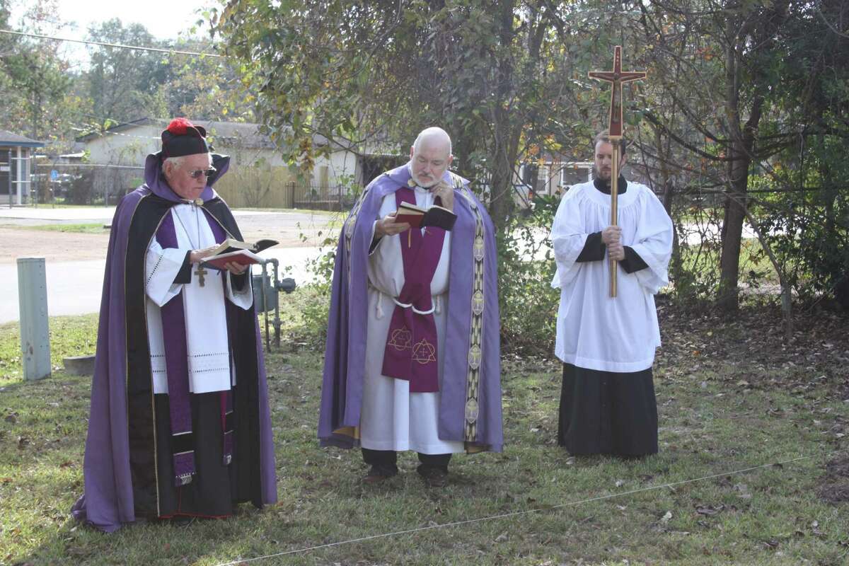 Father James Monroe (left) leads a service at the site of a new sanctuary for Holy Cross Anglican Church in Cleveland on Sunday, Nov. 27. The new building is on Fenner Street across from Croley Center.